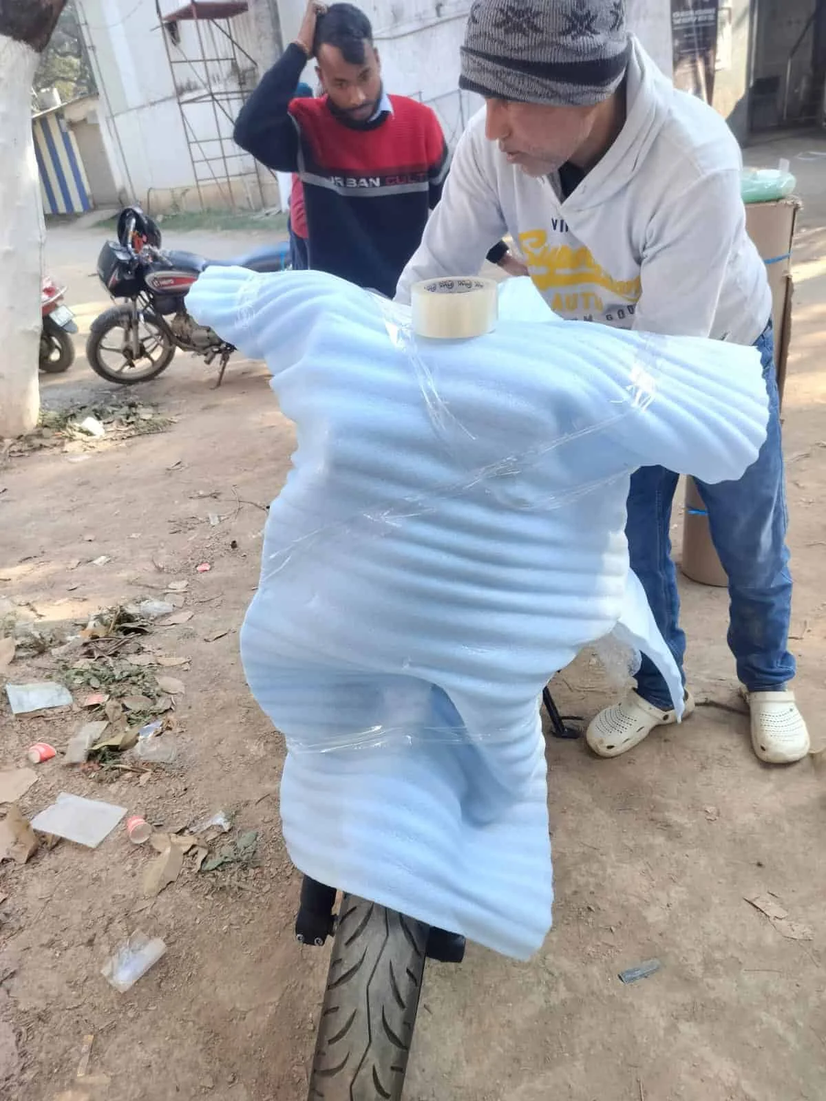 Workers handling packing materials for moving services in Ranchi.